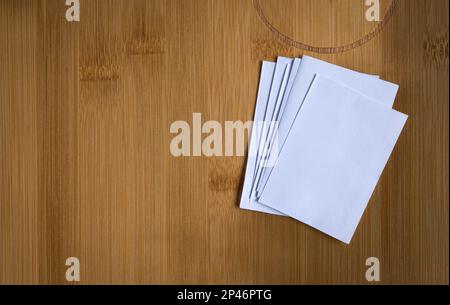 Stack of blank white papers on wooden background. Copy space. Stock Photo