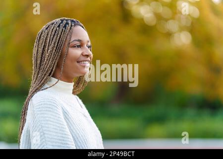 Profile of an african woman looking up in a park Stock Photo