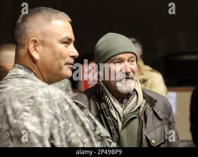 This Dec. 15, 2010 photo released by the U.S. Department of Defense shows actor-comedian Robin Williams, right, with U.S. Army Maj. Gen John F. Campbell, Combined Joint Task Force 101 and Regional Command East commander, before the annual USO Holiday Tour at Bagram Air Field, in Afghanistan. Members of the armed forces have long held special affection for Williams, 63, who died Monday, Aug. 11, 2014 after hanging himself in his San Francisco Bay Area home. Williams never served in the military, but he was a tireless participant in USO shows. (AP Photo/U.S. Department of Defense, Staff Sgt. Mic