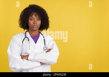 Serious afro doctor with stethoscope looking at camera Stock Photo