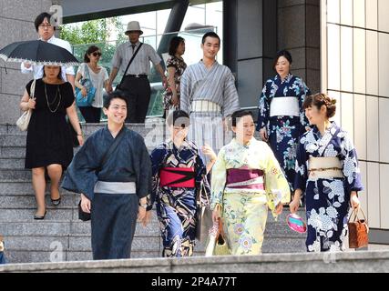 Men wearing yukata head to work in Shibuya Ward, Tokyo on July 30, 2014. As  part of a  Shibuya Summer Festival event to promote traditional Japanese  culture among young people and