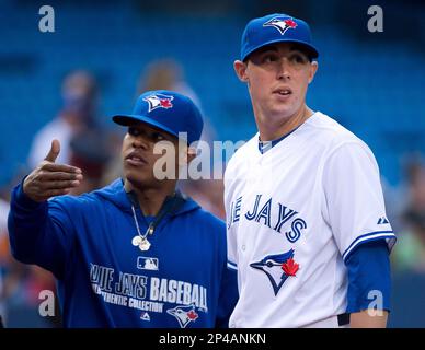 Toronto Blue Jays pitchers Marcus Stroman, right, and Pat Venditte trade  gloves in the first official workout of spring training in Dunedin, Fla.,  on Monday February 22, 2016. Venditte, who is ambidextrous