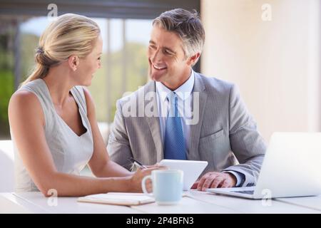 Shes making a good impression. two colleagues working together at a desk. Stock Photo