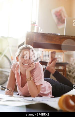 I believe in doing something creative every day. Portrait of a female graphic artist working on illustrations at home. Stock Photo