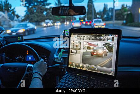 https://l450v.alamy.com/450v/2p4cdyg/tacoma-police-officer-matthew-graham-monitors-an-automatic-license-plater-reader-as-he-cruises-during-a-graveyard-shift-june-21-2014-in-this-photo-the-computers-screen-shows-the-car-seen-at-left-with-the-license-plate-circled-in-red-the-whole-screen-would-have-turned-red-if-the-license-plate-matched-one-from-the-hot-sheet-indicating-a-possible-stolen-car-ap-photo-the-news-tribune-peter-haley-2p4cdyg.jpg