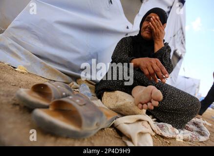 An Iraqi refugee woman from Mosul sits outside her family's tent at Khazir refugee camp outside Irbil, 217 miles (350 kilometers) north of Baghdad, Iraq, Friday, June 13, 2014. The Islamic State of Iraq and the Levant, the al-Qaida breakaway group, on Monday and Tuesday took over much of Mosul in Iraq and then swept into the city of Tikrit further south. An estimated half a million residents fled Mosul, the economically important city. (AP Photo)