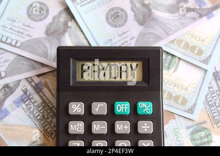 Top view image of money and calculator with text PAYDAY. Finance concept Stock Photo