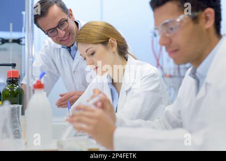 students and teacher experimenting in the lab Stock Photo