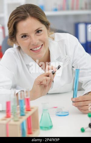 female scientist using magnifying glass Stock Photo