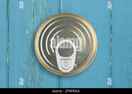 directly above view of can of tinned food on dark wooden table Stock Photo