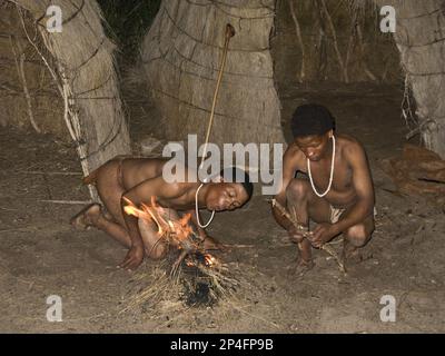 The Bushmen are the oldest inhabitants of southern Africa, here they light a fire with two sticks Stock Photo