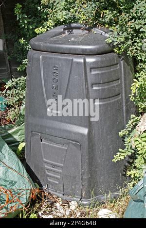 Plastic compost bin in garden, Suffolk, England, United Kingdom Stock Photo