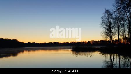 Sonnenaufgang am Angelteich  bei Mantinghausen an einem kalten Wintermorgen Stock Photo