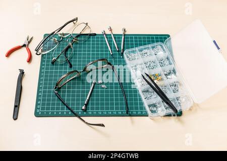 kit for repairing used eyeglasses on wooden table Stock Photo