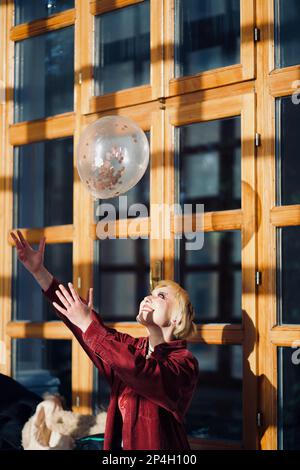 Women in Tall Hallway with Shadows Stock Photo
