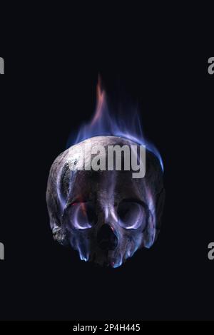 human skull in flames on a black background Stock Photo