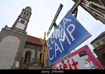 Augsburg, Germany. 06th Mar, 2023. The climate camp between the Perlachturm and the city hall. The camp was initiated by Fridays for Future in mid-2020 and is the oldest uninterrupted climate camp in Germany. Credit: Karl-Josef Hildenbrand/dpa/Alamy Live News Stock Photo