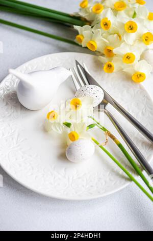 Spring table setting with daffodils Stock Photo