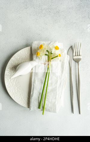 Spring table setting with daffodils Stock Photo