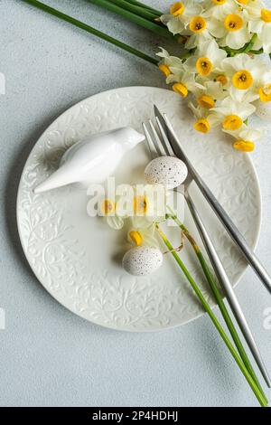 Spring table setting with daffodils Stock Photo