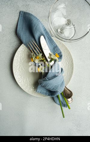 Spring table setting with daffodils Stock Photo