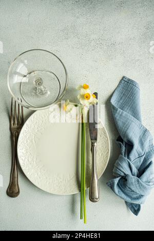 Spring table setting with daffodils Stock Photo