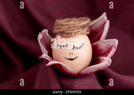 cute sleeping easter chicken egg in middle of tulip petals flowers  Stock Photo