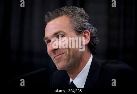 Former Vancouver Canucks' captain Trevor Linden, left, waves as he's  introduced with his wife Cristina for his jersey retirement ceremony prior  to the team's NHL hockey game against the Edmonton Oilers in