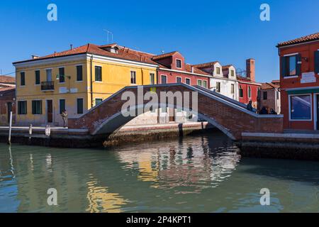 View of Canale di San Donato and Ponte San Martino with colourful buildings and bridge at Murano Island, Venice, Italy in February Stock Photo