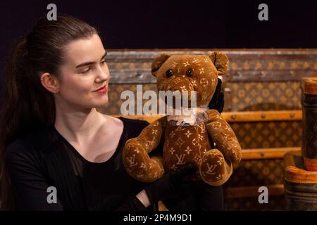 London, UK. 6th Mar, 2023. Louis Vuitton luggage and a DouDou 2005 & 2020  Teddy Bear, Limited edition 2021, est £2,600 - £3,200Preview of Bonhams'  Designer Handbags and Fashion sale at the