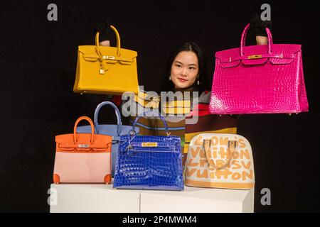 London UK. 6 March 2023. A staff member holds a collection of