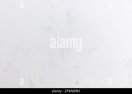 A smeared gray wall with dark translucent strokes. Background. Banner. Texture. Stock Photo