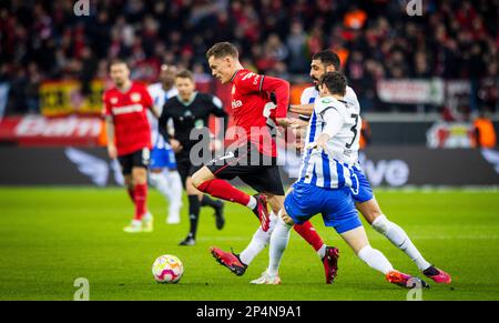 Leverkusen, Germany. 5th Mar, 2023.  Florian Wirtz (Leverkusen), Agustin Rogel (Hertha), Tolga Cigerci (Hertha) Bayer Leverkusen - Hertha BSC Berlin B Stock Photo