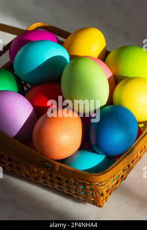 Basket Full of Colorful Dyed Easter Eggs in Rainbow Colors for the Spring Holiday Stock Photo