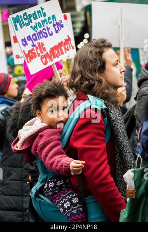 'Migrant Women against Hostile Environment' placard, 'Million Women Rise'  annual march against violence against women, London, UK 04/03/2023 Stock Photo