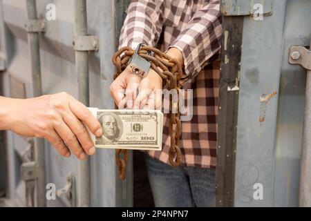 Woman trapped in cargo container wait for Human Trafficking or foreigh workers, Woman holding master key wait for holp help, woman chained to her wris Stock Photo