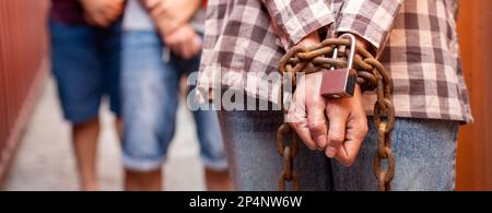 Woman trapped in cargo container wait for Human Trafficking or foreigh workers, Woman holding master key wait for holp help, woman chained to her wris Stock Photo