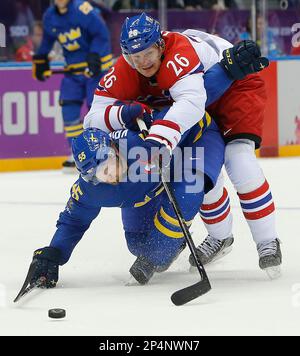 Czech Republic forward Patrik Elias, right, trips over Switzerland forward  Thierry Paterlini during first period action at the IIHF world hockey  championships, Thursday May 8, 2008, in Quebec City. (AP Photo/The Canadian