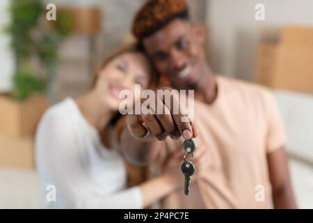 head shot portrait of happy couple in love holding keys Stock Photo