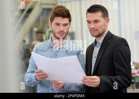planning workers talking in factory Stock Photo