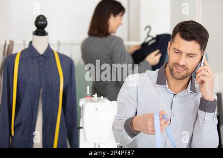 dressmaking design service worker talking on the phone Stock Photo