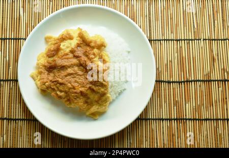 crispy Thai egg omelet topping plain rice on plate Stock Photo