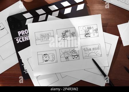 Lay Pattern Process Cartoon Storyboard with cartoon sketches at workplace, flat lay. Pre-production ...