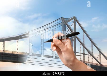 Woman drawing picture of bridge, closeup. Business cooperation concept Stock Photo