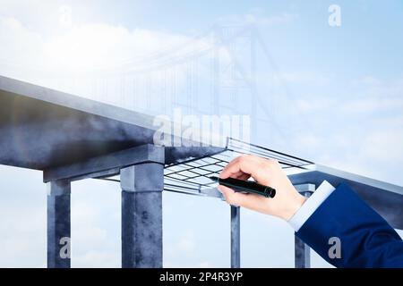 Man drawing picture of bridge, closeup. Business cooperation concept Stock Photo