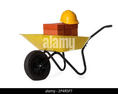 Red bricks and hard hat in wheelbarrow on white background Stock Photo