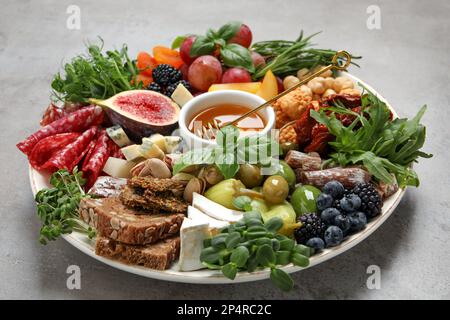 Set of different delicious appetizers served on light grey table Stock Photo