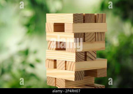 Jenga tower made of wooden blocks outdoors Stock Photo