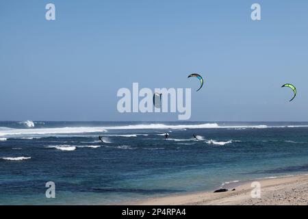 Saint-Pierre, La Réunion - June 09 2017: People enjoying kite surfing during lunch break at the beach in Saint-Pierre de la Reunion. Stock Photo