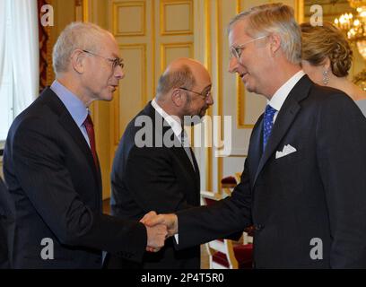 Belgium's King Philippe, right, shakes hands with European Council President Herman Van Rompuy, during a New Year's reception at the Royal Palace in Brussels, Friday Jan. 10, 2014. Belgium's King Philippe invited EU officials from all the EU institutions in Brussels, for the annual New Year's reception. (AP Photo/Eric Lalmand, pool)